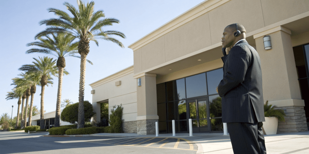 Professional guard from a private armed security company on duty at a corporate building.