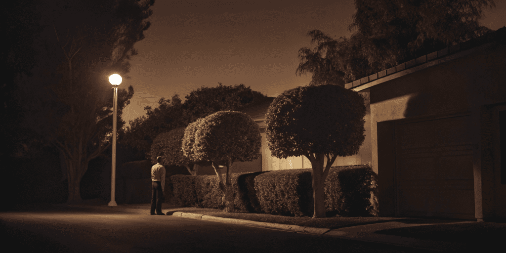 Residential security guard on night patrol in a neighborhood.