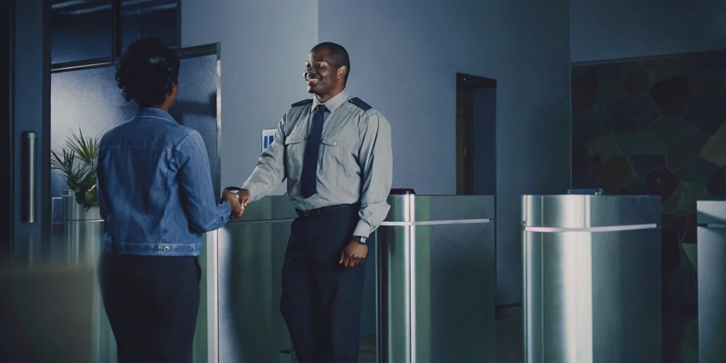 Office security guard greeting a visitor at reception