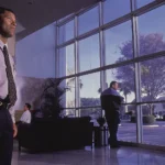 Unarmed security officer monitoring a modern office lobby