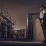Professional security guard patrolling a Los Angeles construction site at dusk