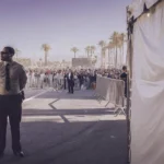 Professional security guard monitoring an outdoor event entrance in Southern California