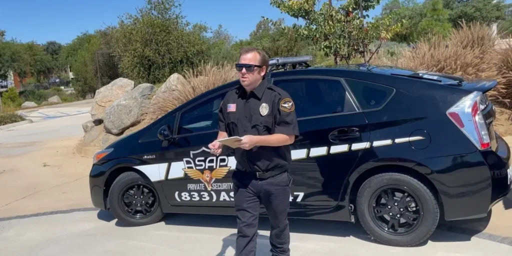 Uniformed security guard standing at the entrance of a Southern California gated community