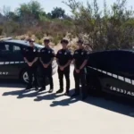 ASAP Security Guards patrol team beside marked vehicles for vacant property security